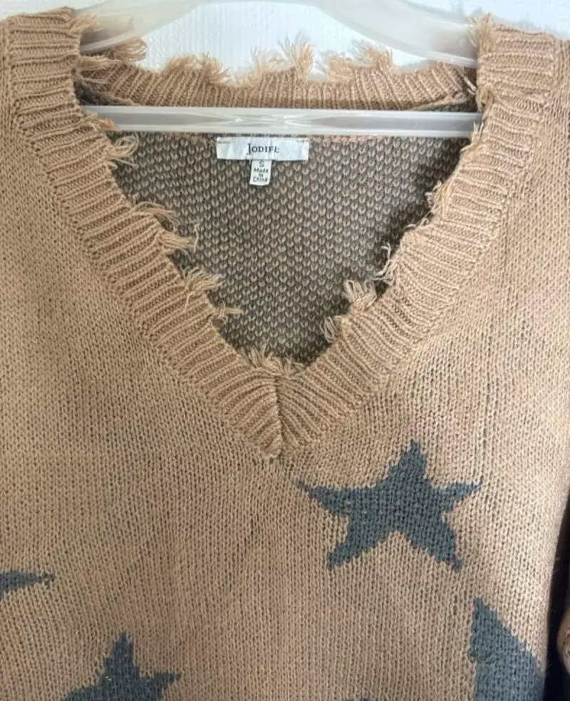 Suéter beige con estrellas y diseño desgastado - 2