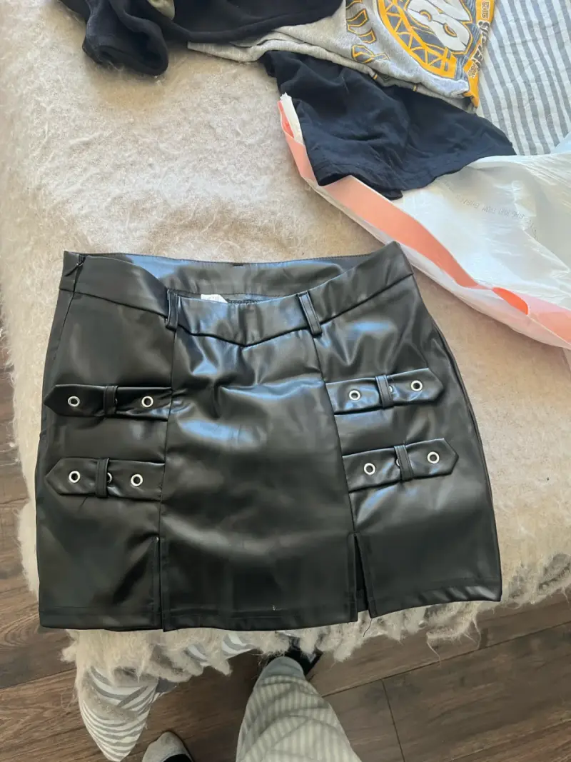 Falda corta de cuero sintético negra con hebillas