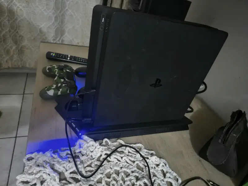 Consola PlayStation 4 con dos controles y juego - 2