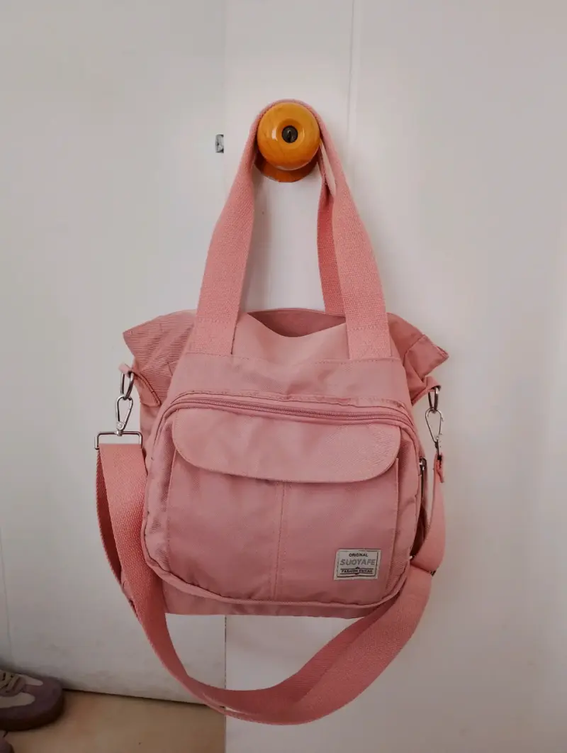 Bolso tote rosa con múltiples compartimentos - 1
