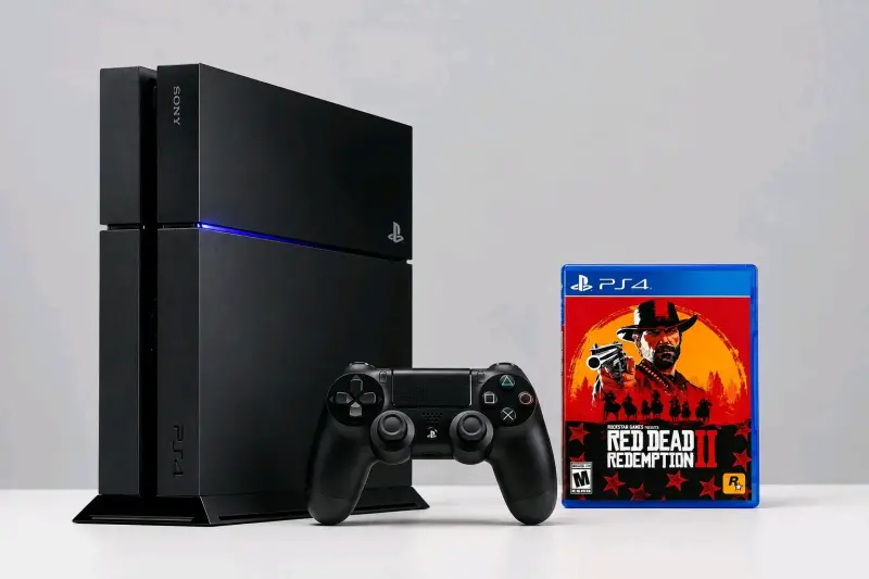 Consola PS4 con control y juego Red Dead Redemptio