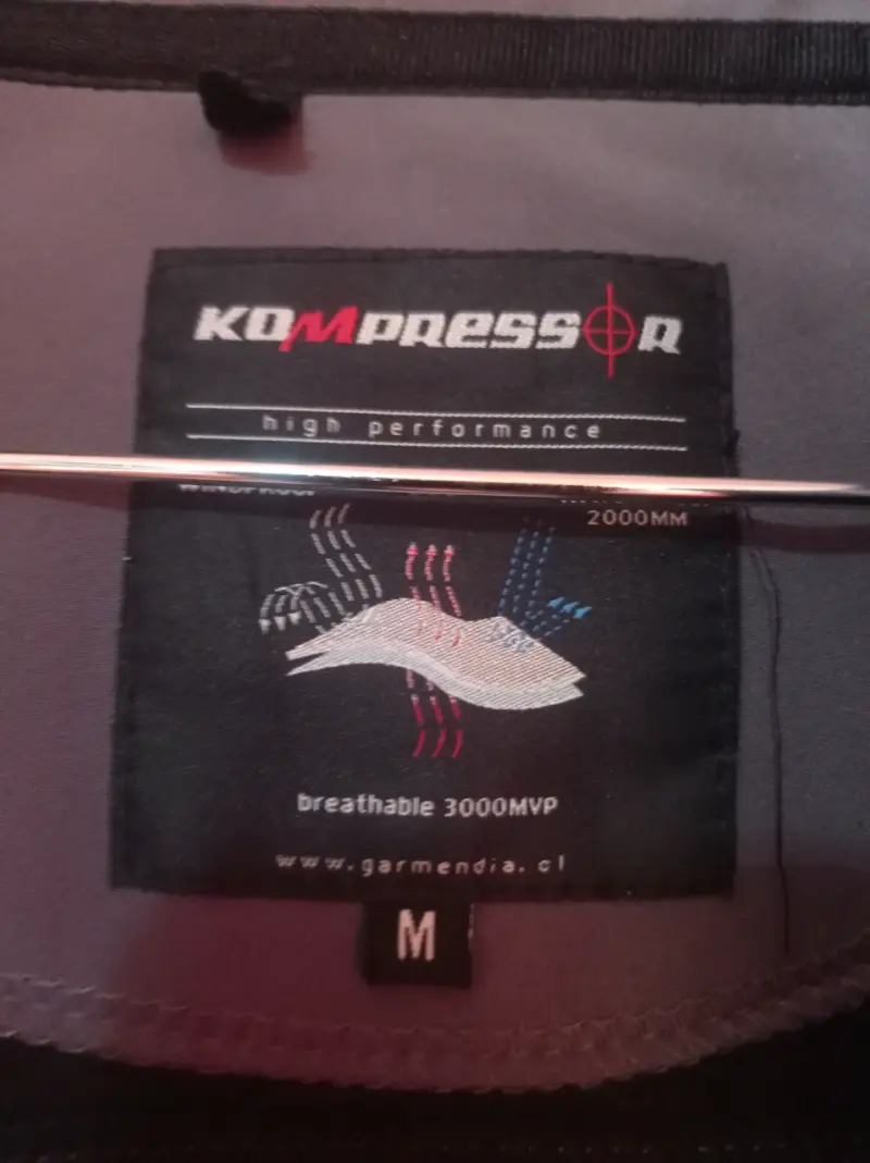Chaqueta Kompressor impermeable gris con detalles naranjas