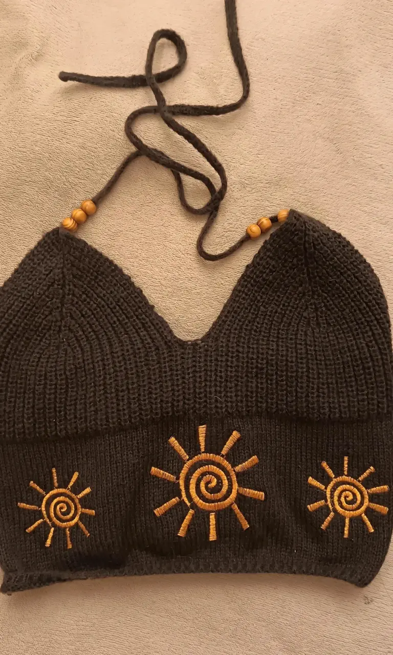 Top tejido negro con diseño de soles