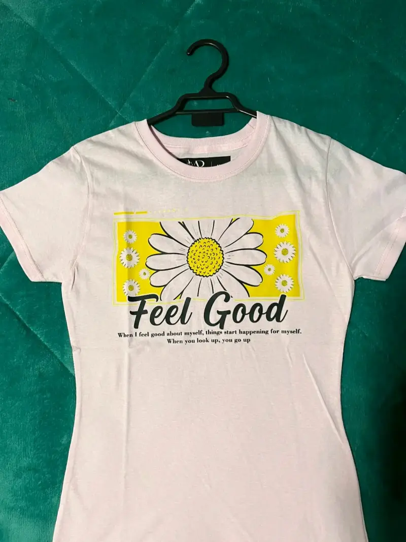 Polera rosa con diseño de margarita y texto 'Feel Good'