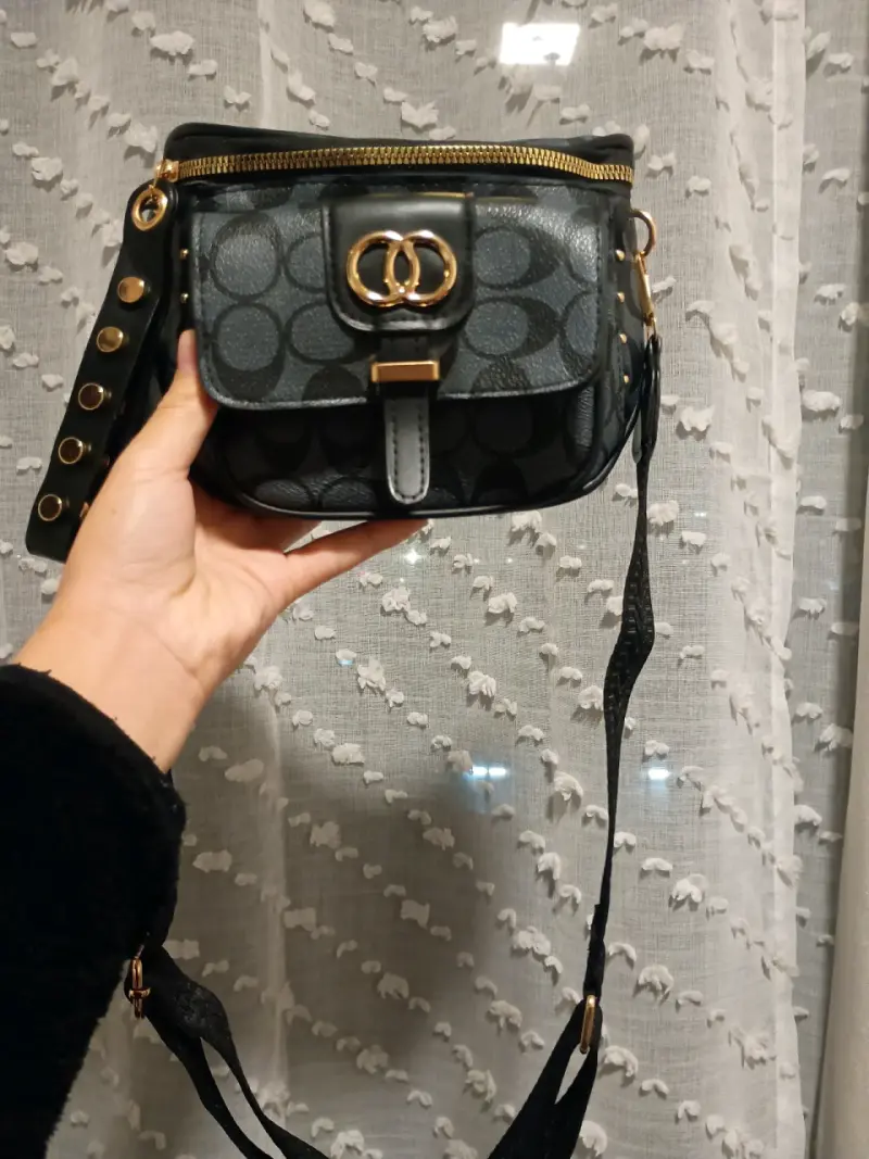 Cartera bandolera negra con detalles dorados