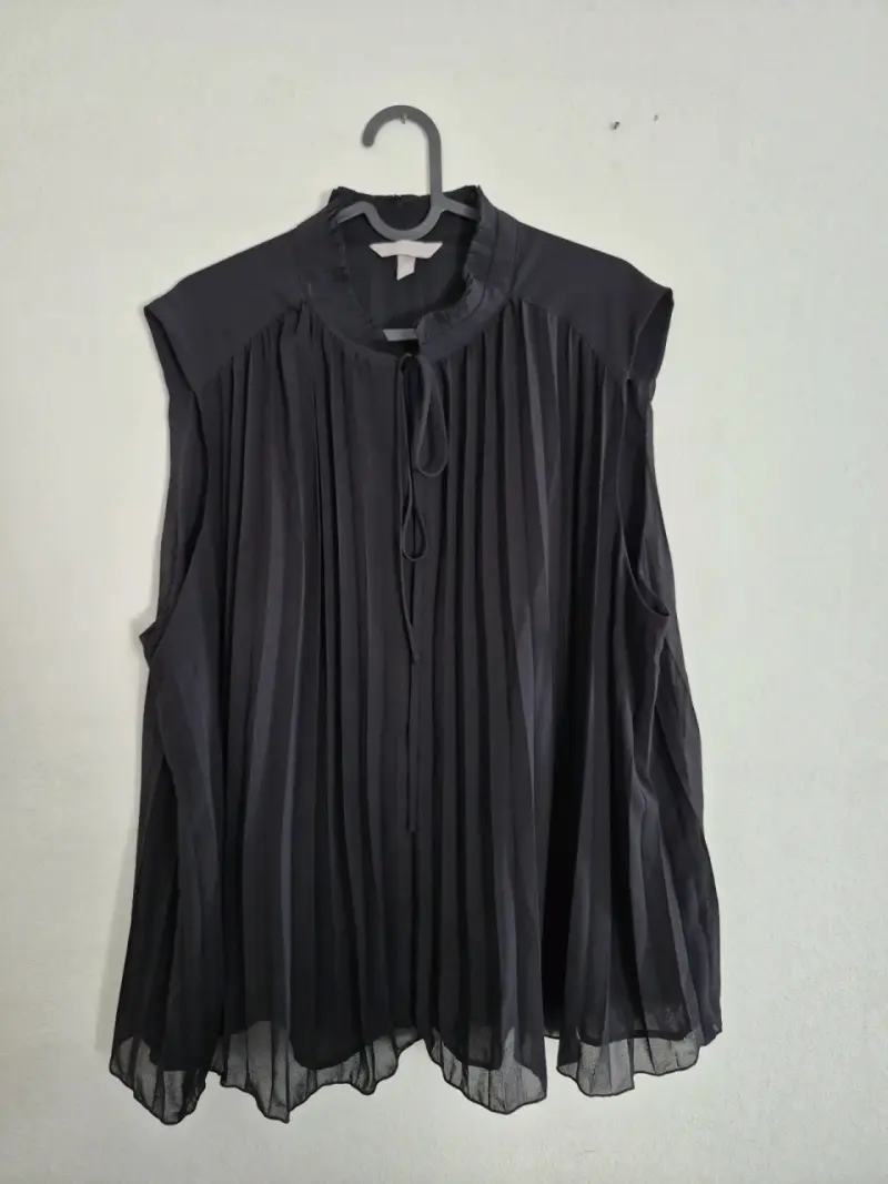 Blusa negra plisada sin mangas
