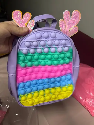 Mochila infantil pop it multicolor con orejas - miniatura 1