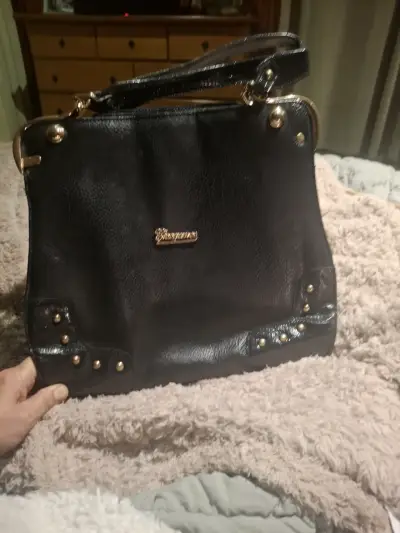 Cartera negra elegante con detalles dorados - miniatura 1