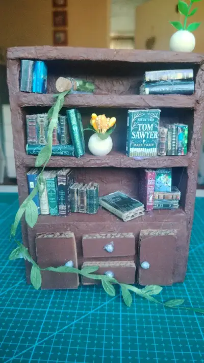 Mini estantería decorativa con libros y planta - miniatura 1