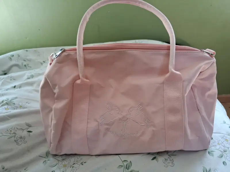 Bolso de mano rosado con diseño de conejos