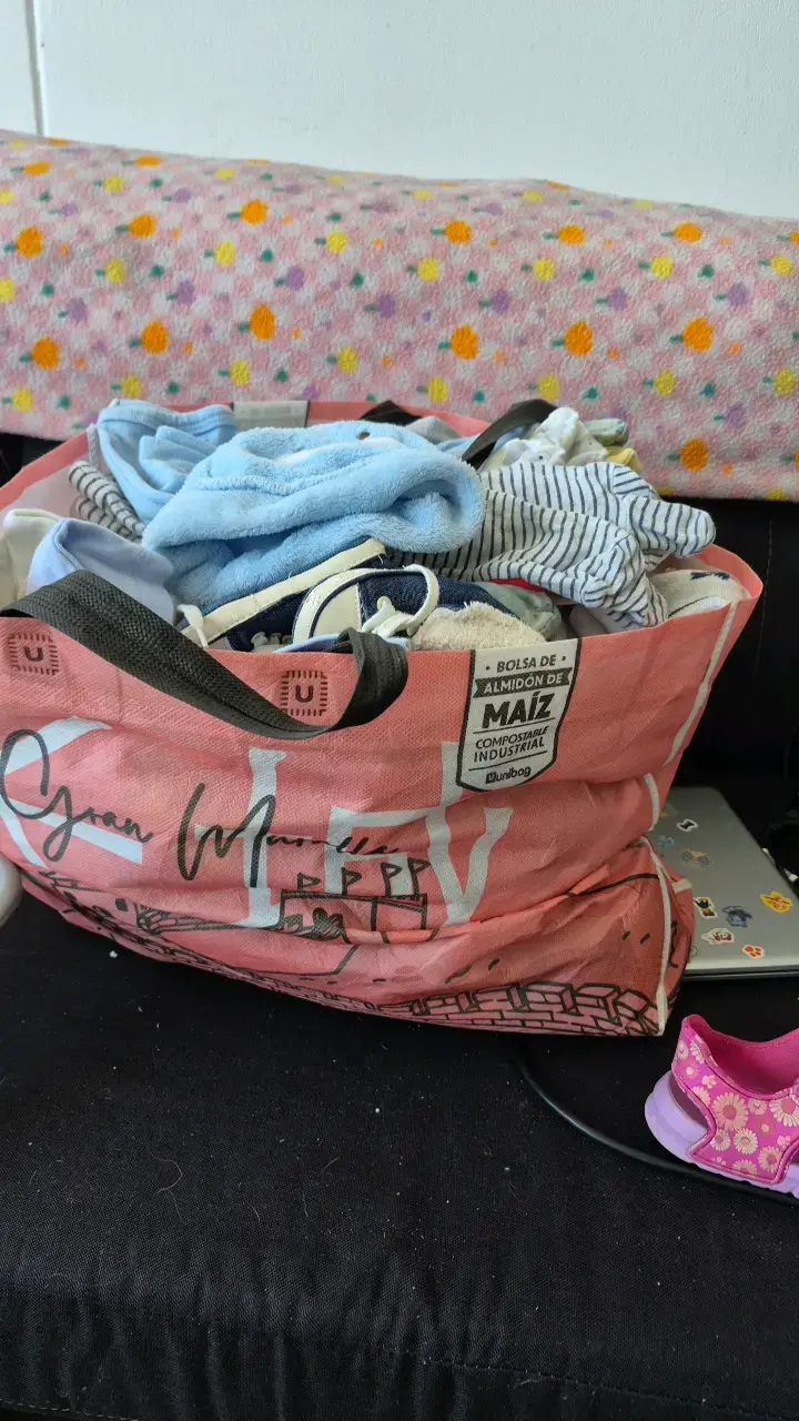 Ropa de bebé variada en bolsa reutilizable