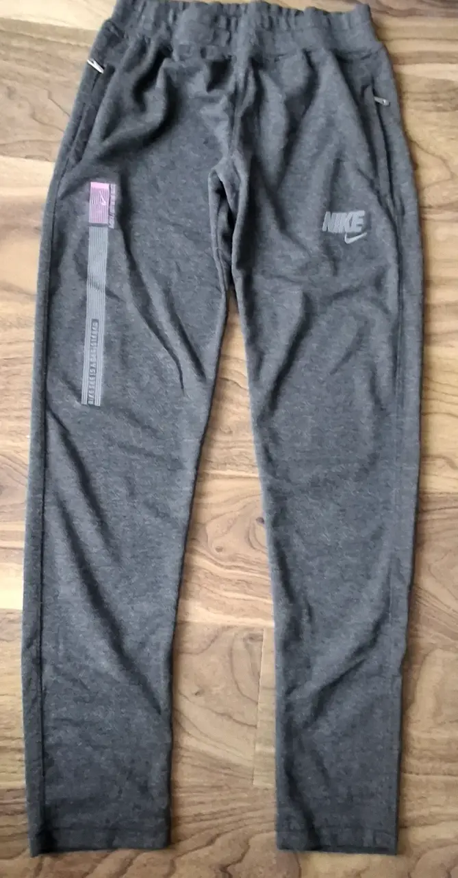 Pantalones deportivos Nike grises con cierre - 1