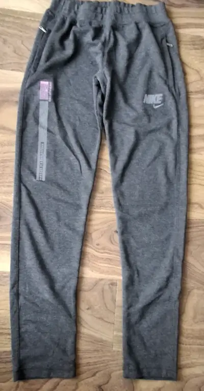 Pantalones deportivos Nike grises con cierre - miniatura 1
