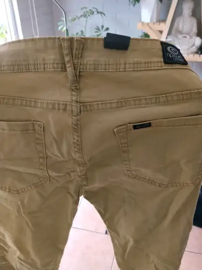 Pantalones Rip Curl mostaza niña - miniatura 1