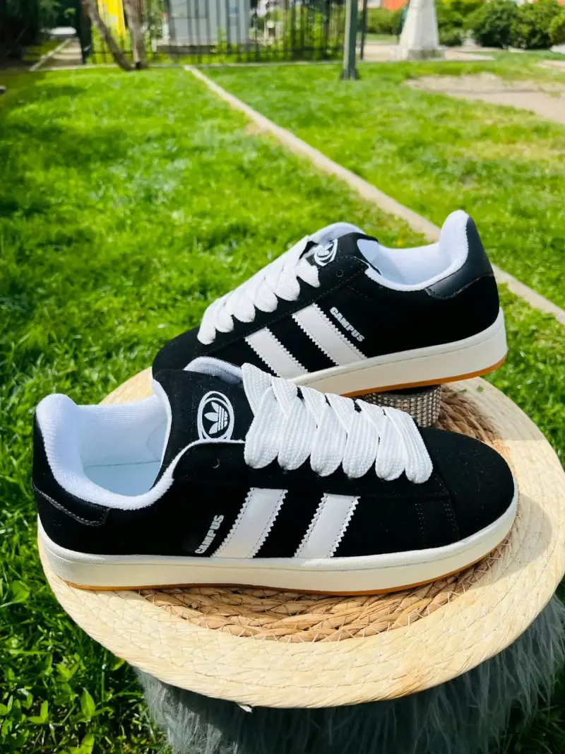 Zapatillas deportivas negras con rayas blancas