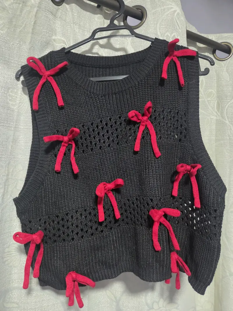 Chaleco tejido negro con lazos rojos