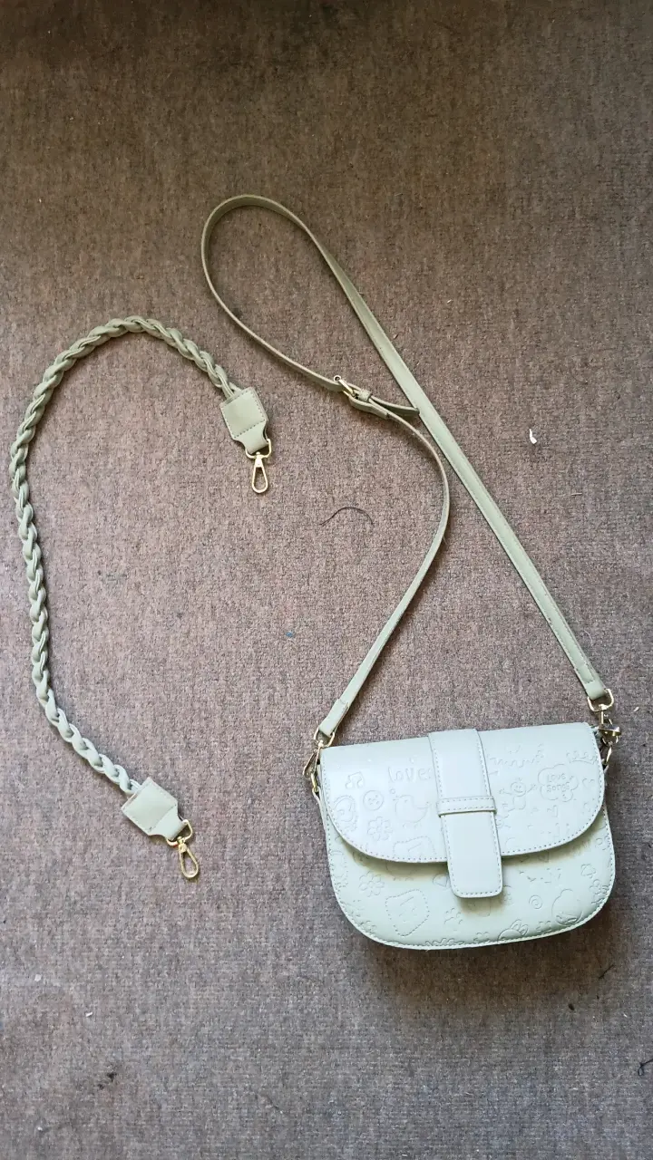 Cartera con correa ajustable y diseño grabado