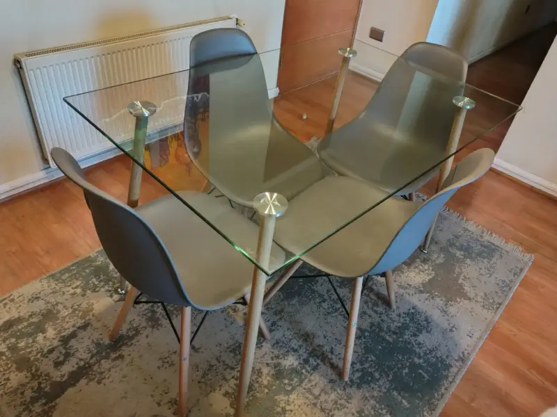 Juego de comedor con mesa de vidrio y sillas grises - 1