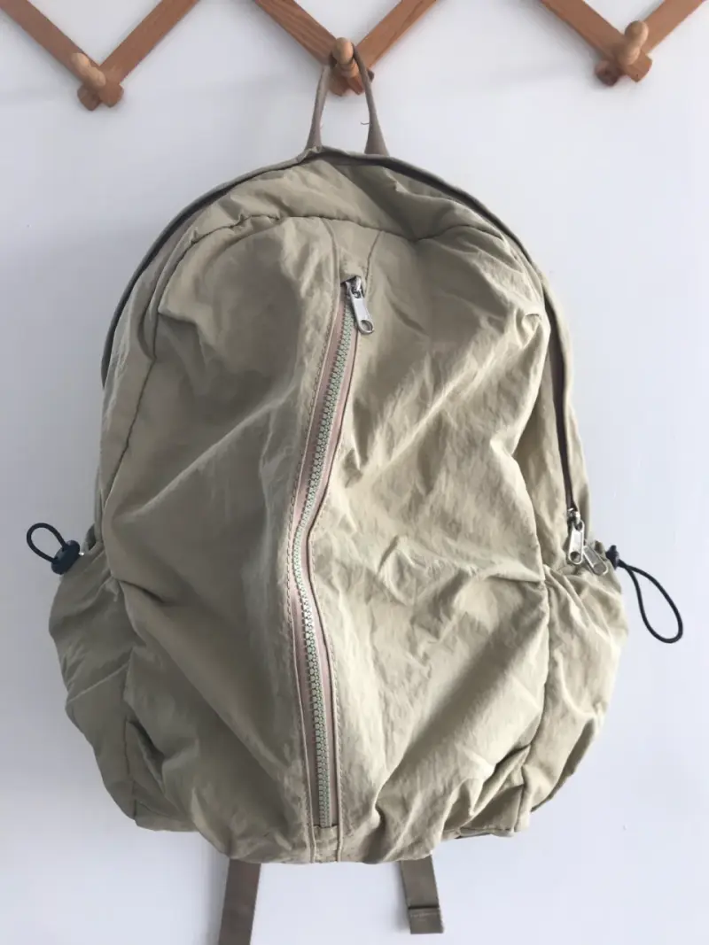 Mochila beige con múltiples compartimentos - 1