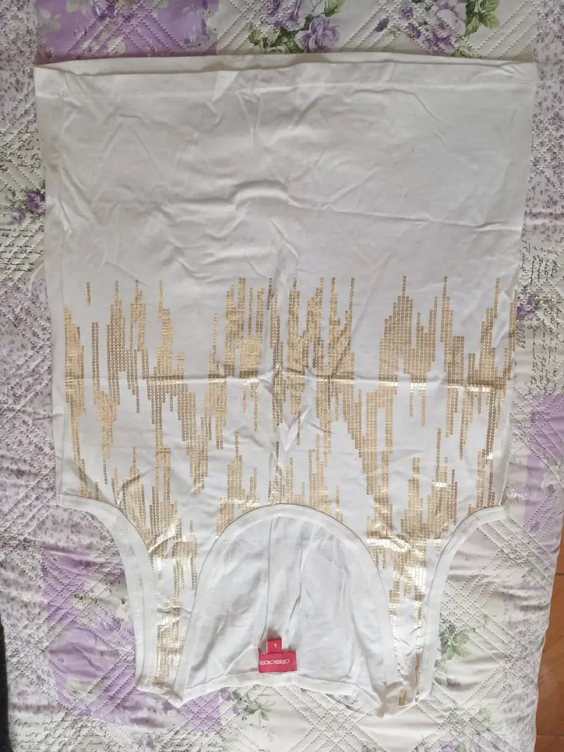 Polera sin mangas blanca con diseño dorado