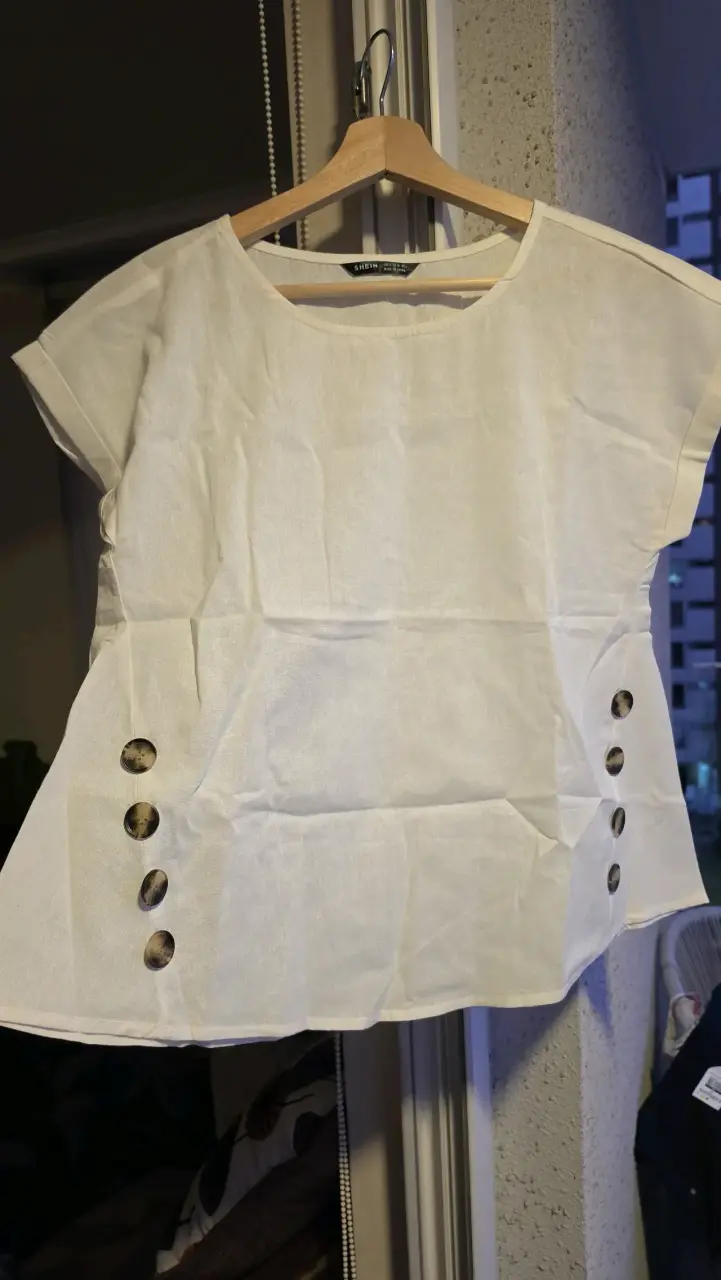 Blusa blanca con botones decorativos