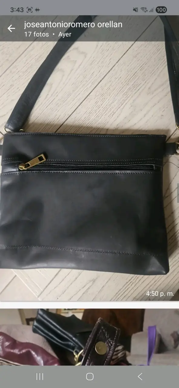 Cartera negra de cuero con cierre dorado - 1