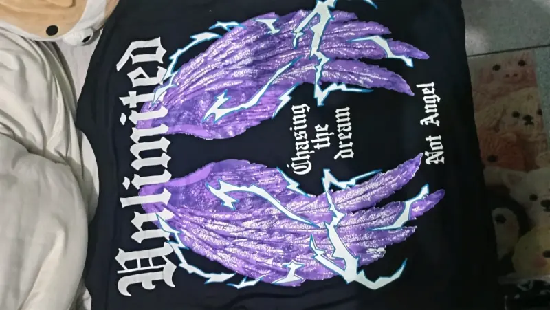 Polera negra con diseño de alas moradas - 1