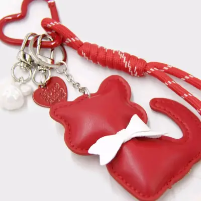 Llavero de gato rojo con lazo blanco - miniatura 1