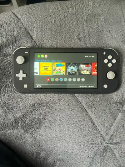 Nintendo Switch Lite gris en buen estado - miniatura 1