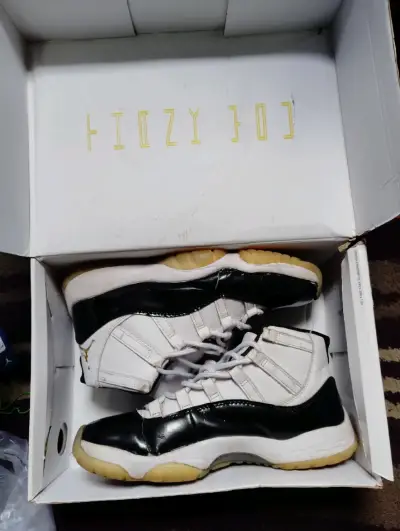 Zapatillas deportivas blancas y negras con logo dorado - miniatura 1