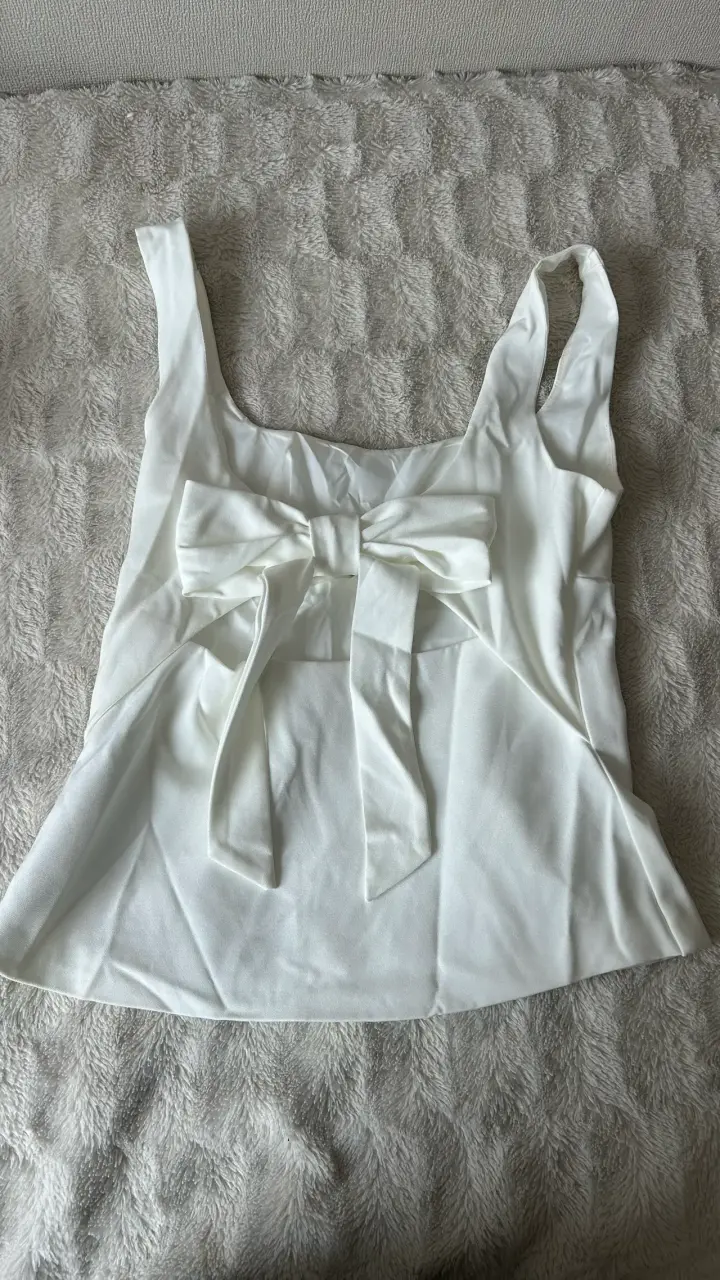 Blusa blanca sin mangas con lazo decorativo - 2