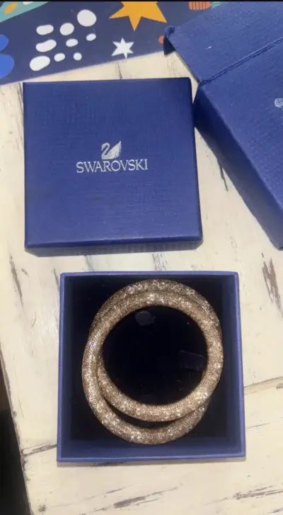 Pulsera Swarovski dorada en caja original - miniatura 1