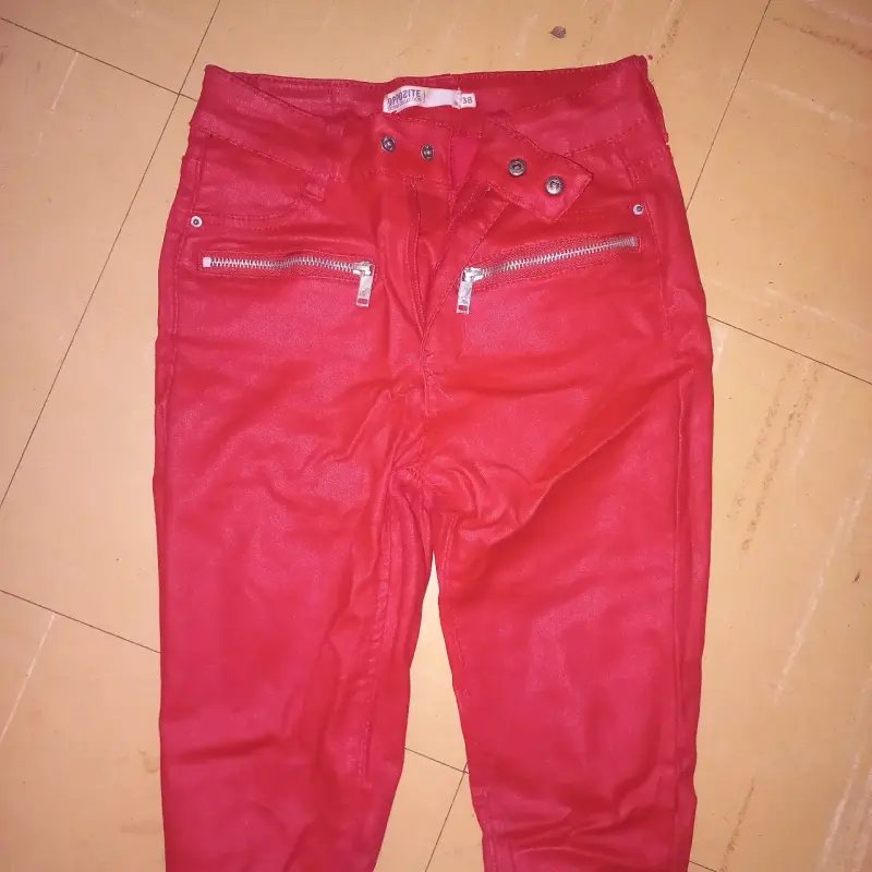 Pantalones rojos con cierres metálicos